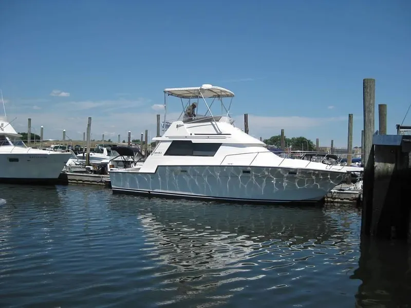 Slide: The Image of 1989 Luhrs 342 Tournament yacht docked at a marina on a sunny day. - 3
