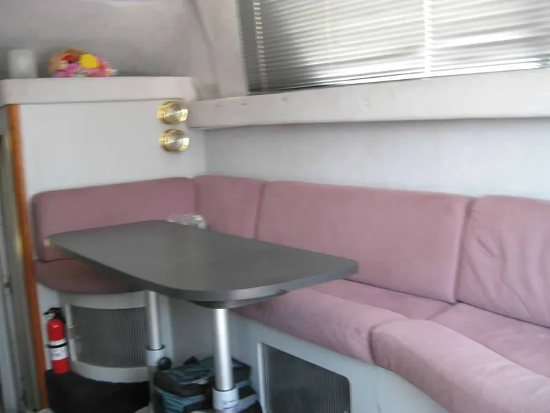 Slide: The Image of Interior of 1989 Luhrs 342 Tournament boat with pink seating and dining table. - 4