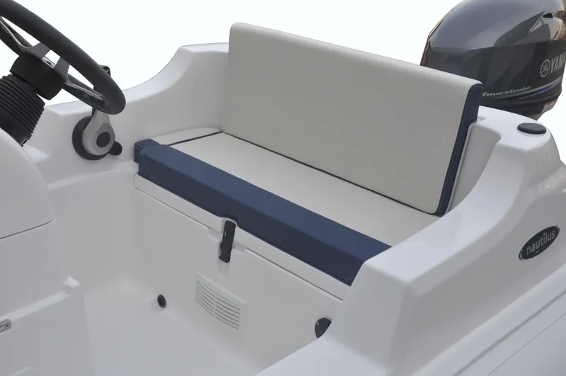 Slide: The Image of 2023 AB Inflatables 11 DLX boat interior with cushioned seating and steering console. - 3