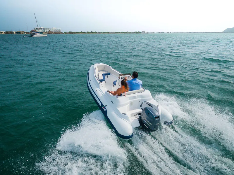 Slide: The Image of 2024 AB Inflatables 15 DLX boat cruising on open water. - 14