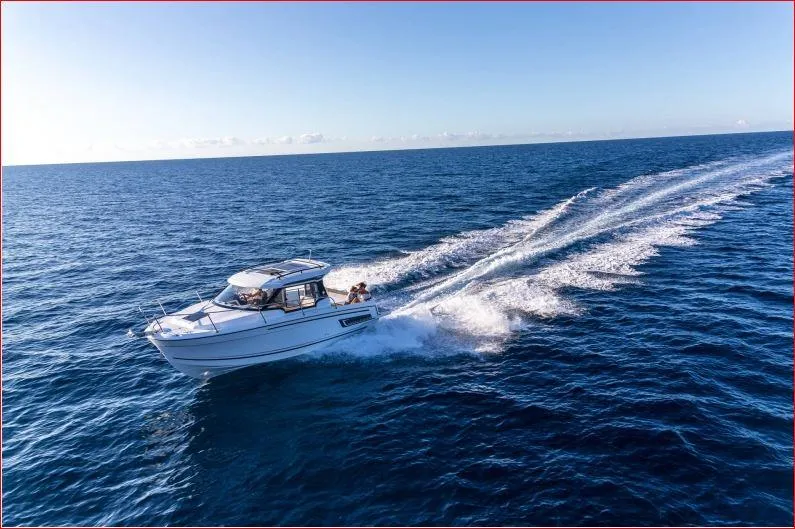 Slide: The Image of 2024 Jeanneau NC 795 cruising on open water. - 11