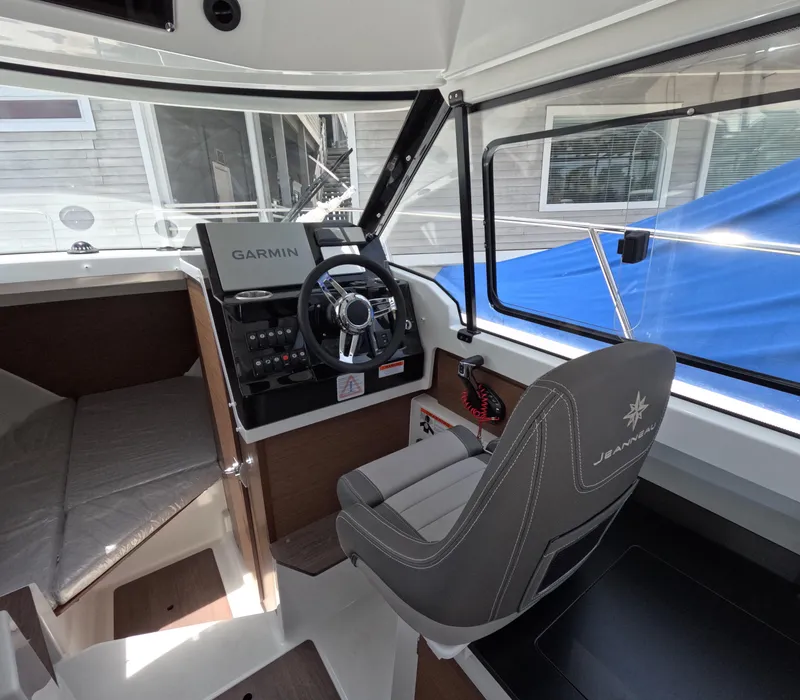 Slide: The Image of 2024 Jeanneau NC 795 boat interior with Garmin navigation system and captain's chair. - 3