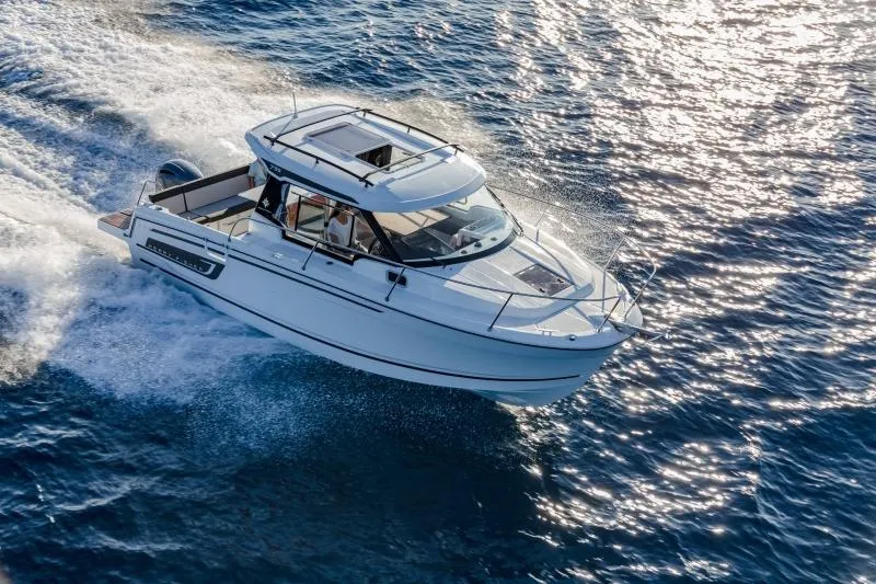 Slide: The Image of 2024 Jeanneau NC 795 motorboat cruising on open water. - 31
