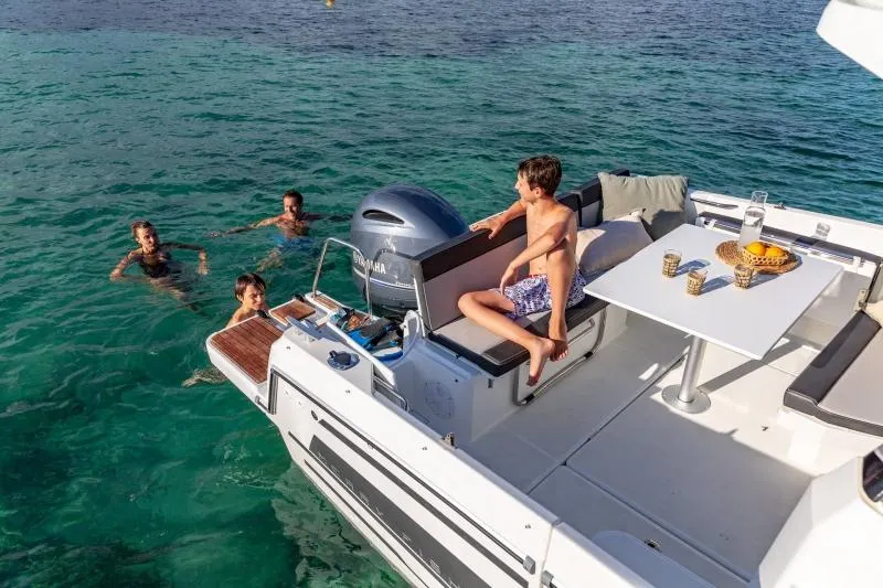 Slide: The Image of 2024 Jeanneau NC 795 boat with people swimming and relaxing. - 33