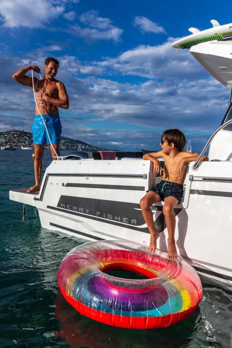 Slide: The Image of Man and child enjoying a day on a 2024 Jeanneau NC 795 boat. - 39