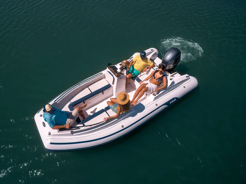 Slide: The Image of 2024 AB Inflatables 17 DLX boat with passengers on the water. - 9