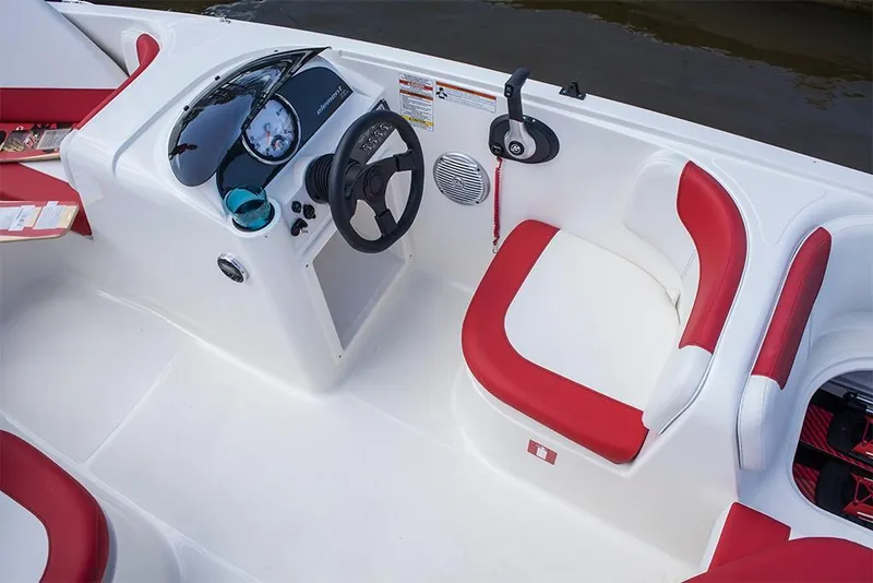 Slide: The Image of 2023 Bayliner Element E18 boat interior with red and white seating and steering console. - 18
