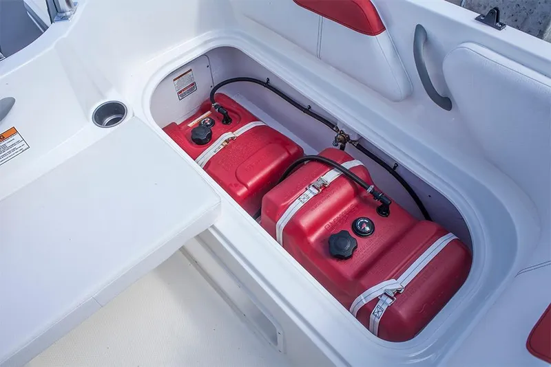 Slide: The Image of 2023 Bayliner Element E18 boat storage compartment with red fuel tanks. - 20