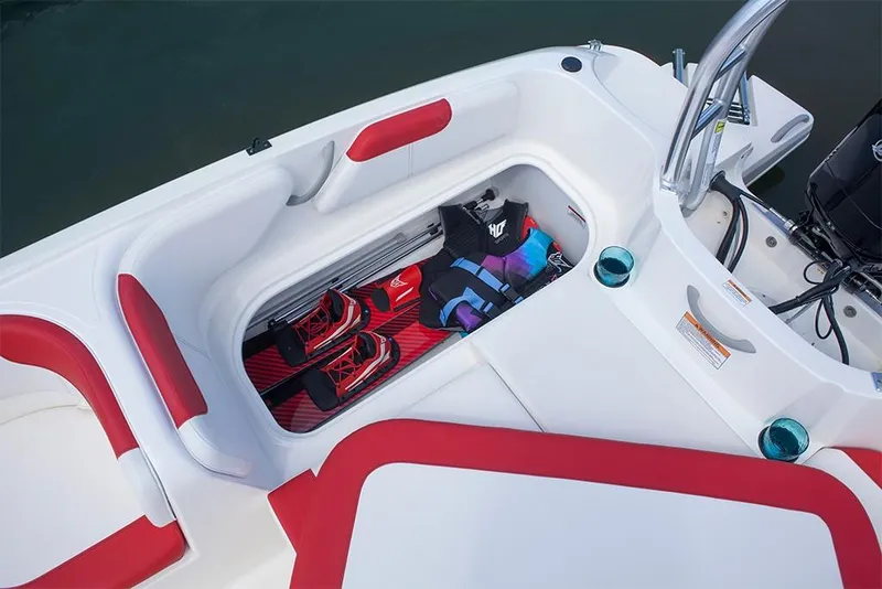 Slide: The Image of 2023 Bayliner Element E18 boat storage compartment with life jacket and water skis. - 23