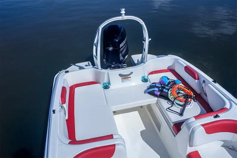 Slide: The Image of 2023 Bayliner Element E18 boat interior with red and white seating, life jackets, and water accessories. - 24