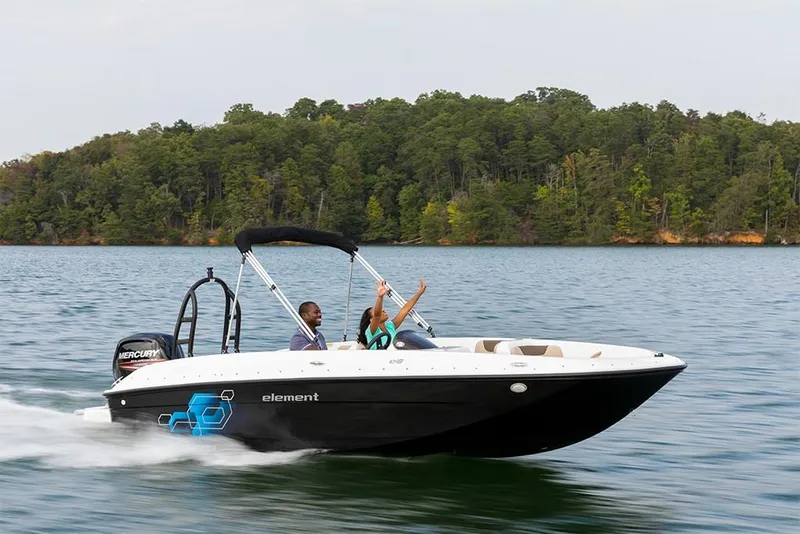 Slide: The Image of 2023 Bayliner Element E18 boat cruising on a lake with passengers. - 27