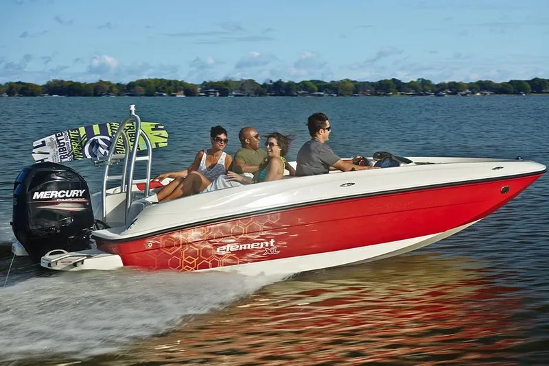 Slide: The Image of 2023 Bayliner Element E18 boat cruising on a lake with passengers. - 29