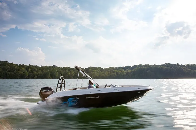 Slide: The Image of 2023 Bayliner Element E18 boat speeding on a lake. - 31