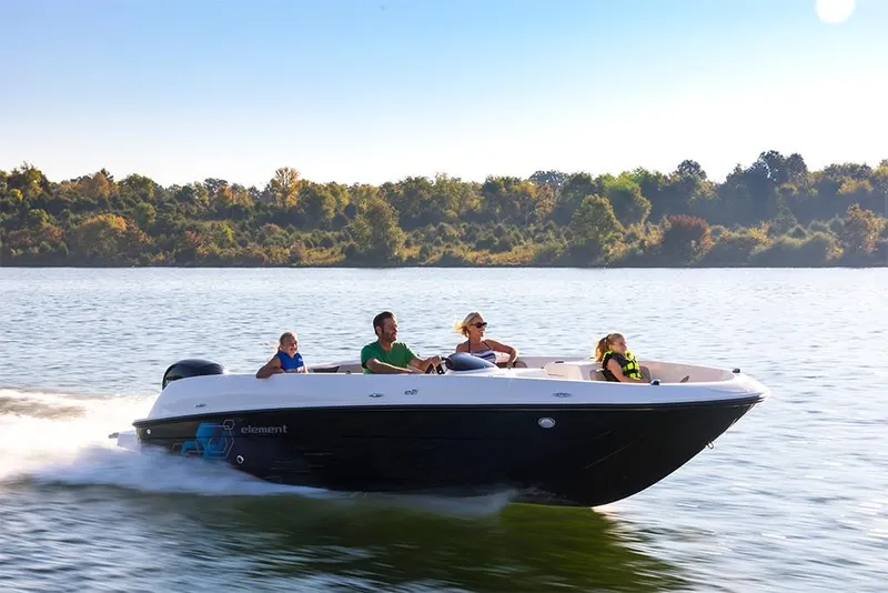 Slide: The Image of 2023 Bayliner Element E21 boat cruising on a lake with passengers. - 14