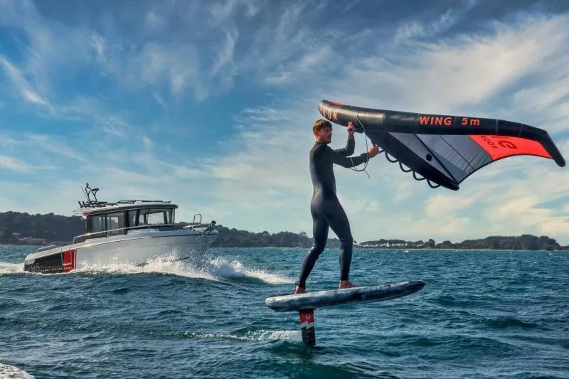 Slide: The Image of 2023 Jeanneau NC795 Sport Series 2 boat cruising on water at sunset. - 21