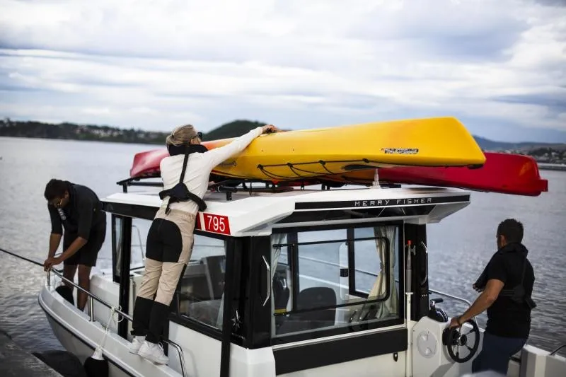 Slide: The Image of 2023 Jeanneau NC795 Sport Series 2 boat cruising on open water. - 27