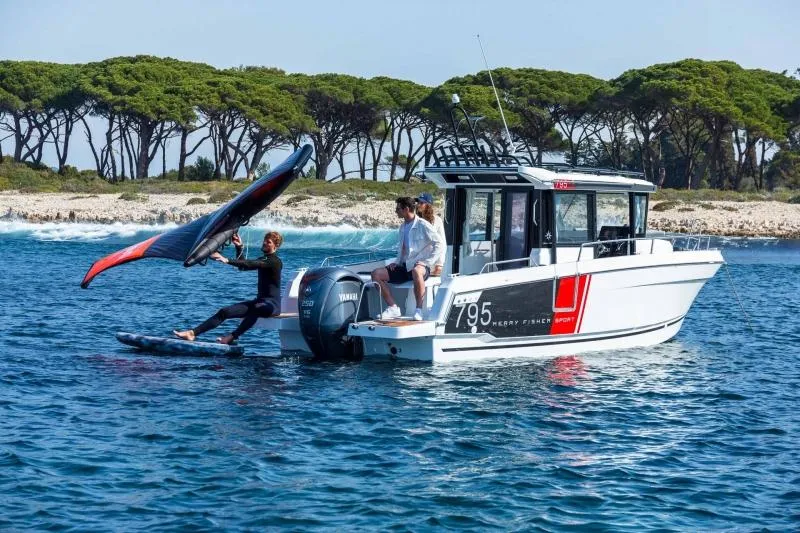 Slide: The Image of 2023 Jeanneau NC795 Sport Series 2 boat with people boarding at a dock. - 5