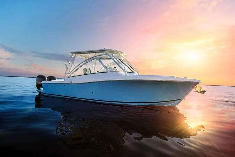 Slide: The Image of 2023 Albemarle 27 Dual Console boat on calm water at sunset. - 10