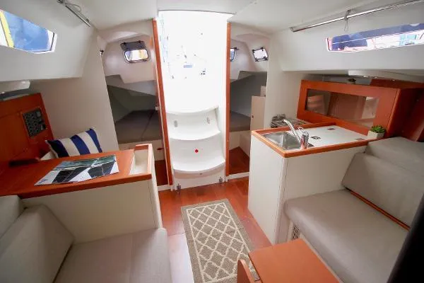 Slide: The Image of 2024 J Boats J/99 interior with modern design, compact kitchen, and cozy seating area. - 11