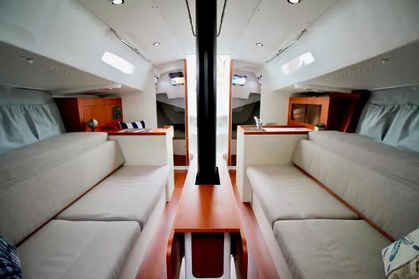 Slide: The Image of Interior of 2024 J Boats J/99 sailboat, featuring modern seating and wood accents. - 14