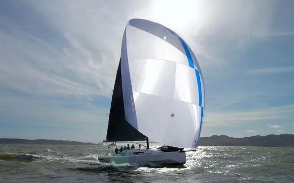 Slide: The Image of 2024 J Boats J/99 sailing with spinnaker on open water. - 2