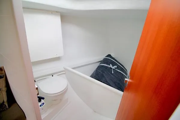 Slide: The Image of 2024 J Boats J/99 interior bathroom with toilet and storage area. - 20