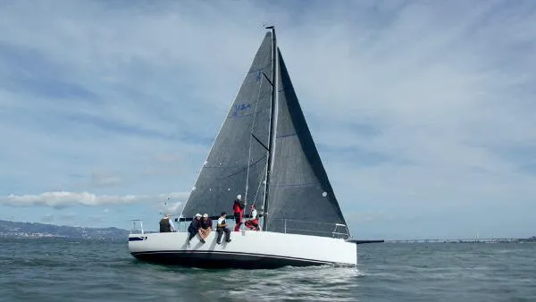 Slide: The Image of 2024 J Boats J/99 sailing on open water with crew onboard. - 3