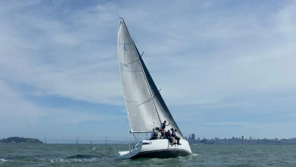Slide: The Image of 2024 J Boats J/99 sailing on open water with city skyline in background. - 5