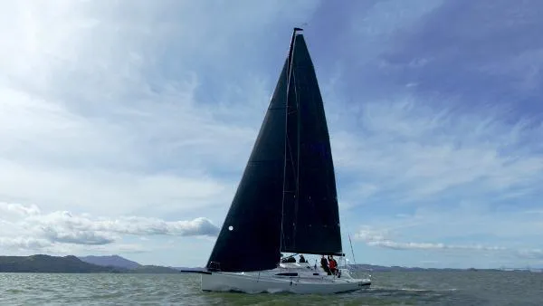 Slide: The Image of 2024 J Boats J/99 sailing on open water under a clear sky. - 6