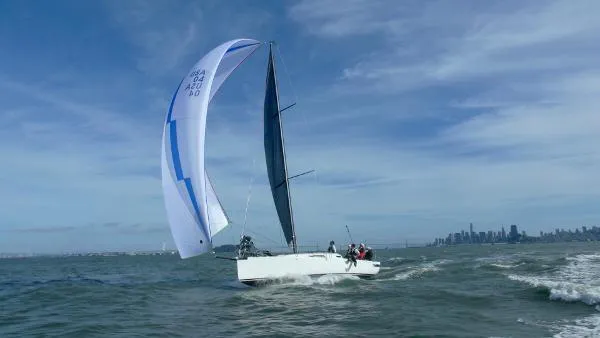 Slide: The Image of 2024 J Boats J/99 sailing on open water with city skyline in background. - 8