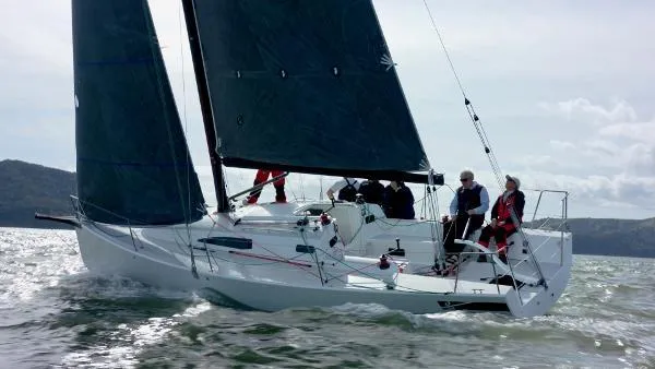 Slide: The Image of 2024 J Boats J/99 sailing on open water with crew onboard. - 9