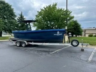 Slide: The Image of 2018 Lekker Damsko 750 Open boat on trailer in parking lot. - 10