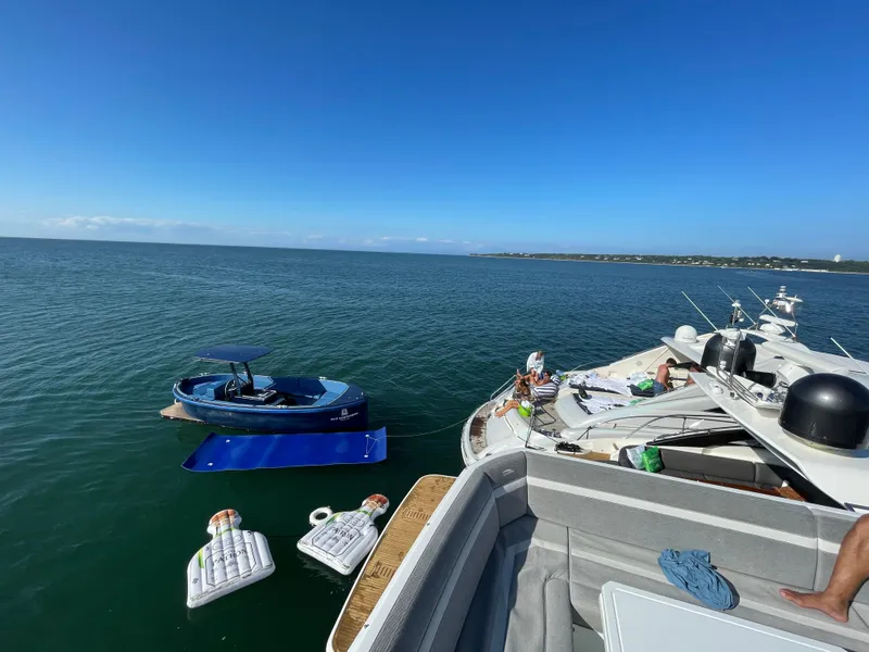 Slide: The Image of A 2018 Lekker Damsko 750 boat on calm water with inflatables and clear blue sky. - 15