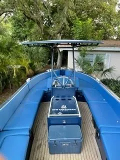 Slide: The Image of 2018 Lekker Damsko 750 Open boat with blue seating and canopy, docked near trees. - 9