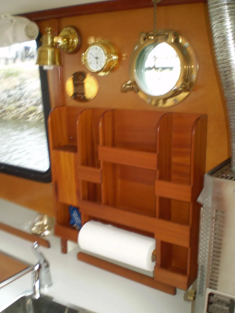 Slide: The Image of Wooden interior of 2000 Devlin Surf Scoter boat with nautical decor and storage. - 17