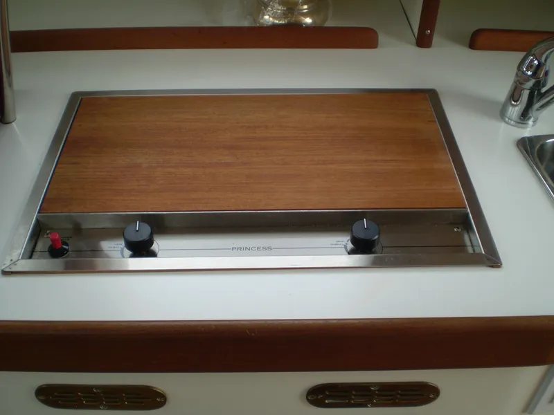 Slide: The Image of Stovetop on 2000 Devlin Surf Scoter boat with wooden cover and control knobs. - 19