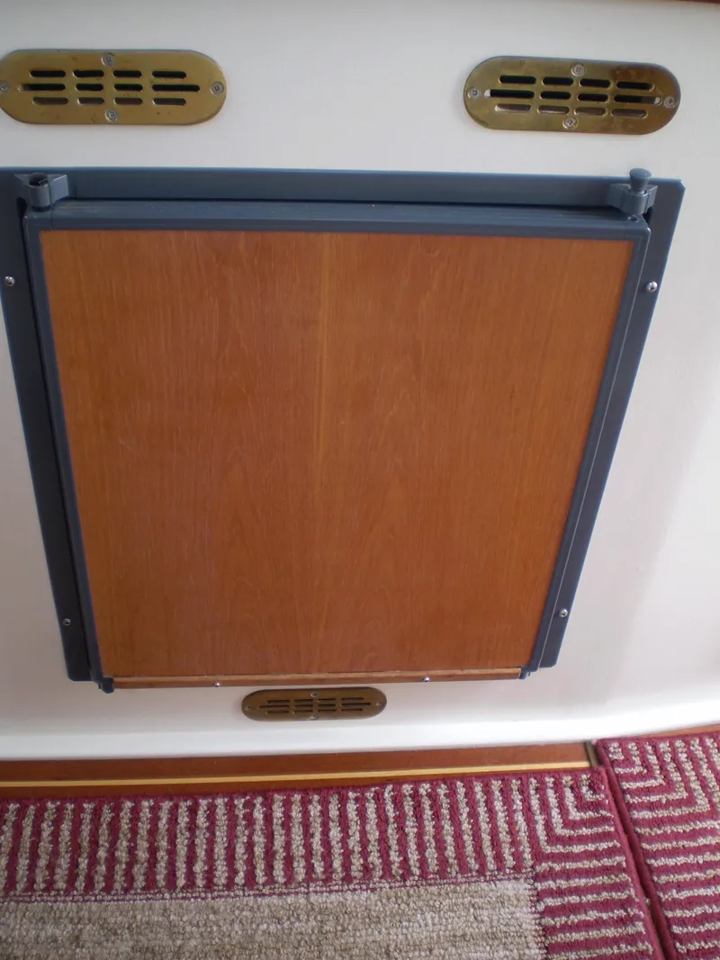 Slide: The Image of Wooden panel on a 2000 Devlin Surf Scoter boat with ventilation grilles. - 21