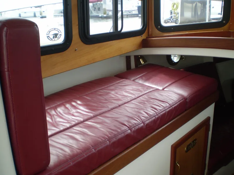 Slide: The Image of Red leather seating inside a 2000 Devlin Surf Scoter boat cabin. - 24