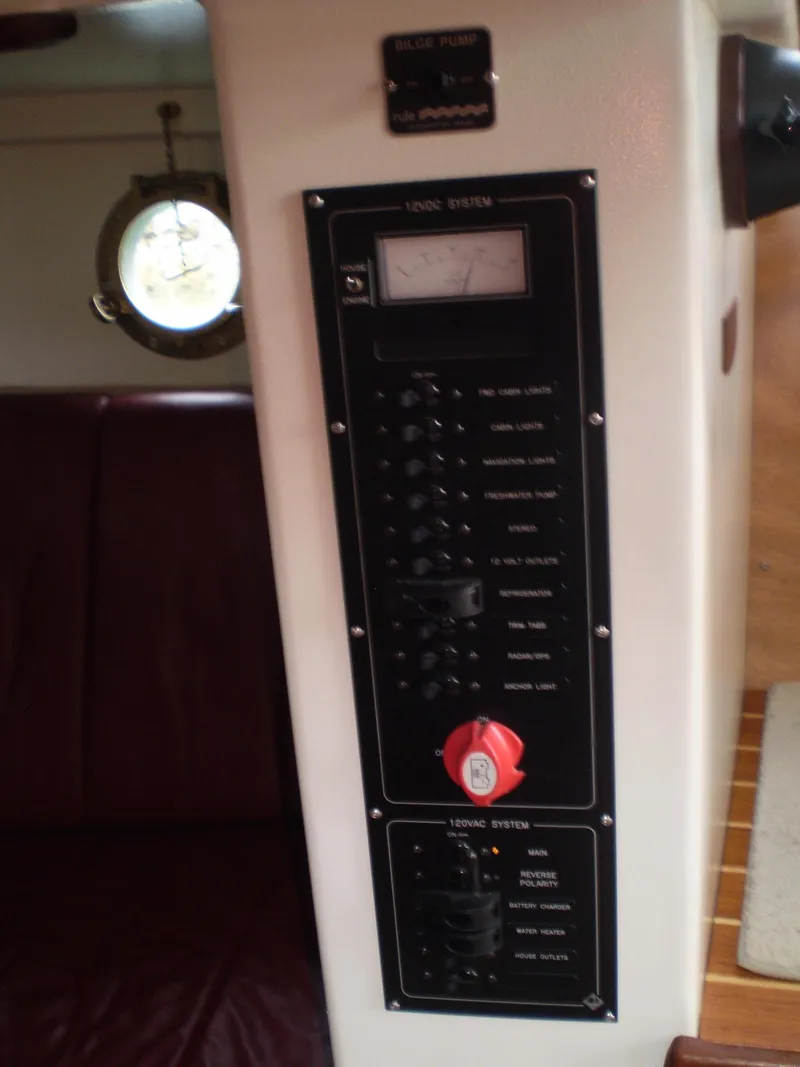 Slide: The Image of Electrical panel inside 2000 Devlin Surf Scoter boat, featuring switches and gauges. - 31