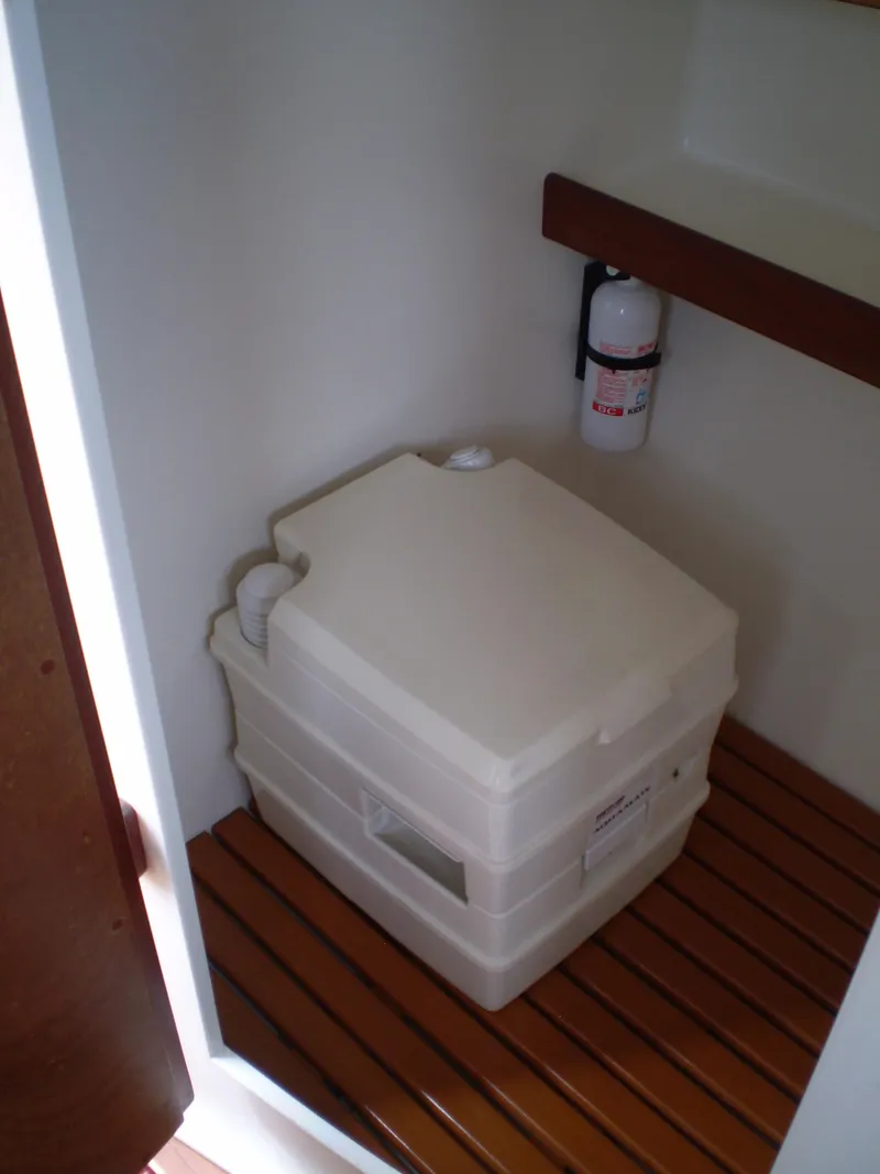 Slide: The Image of Portable toilet in 2000 Devlin Surf Scoter boat with wooden flooring. - 36