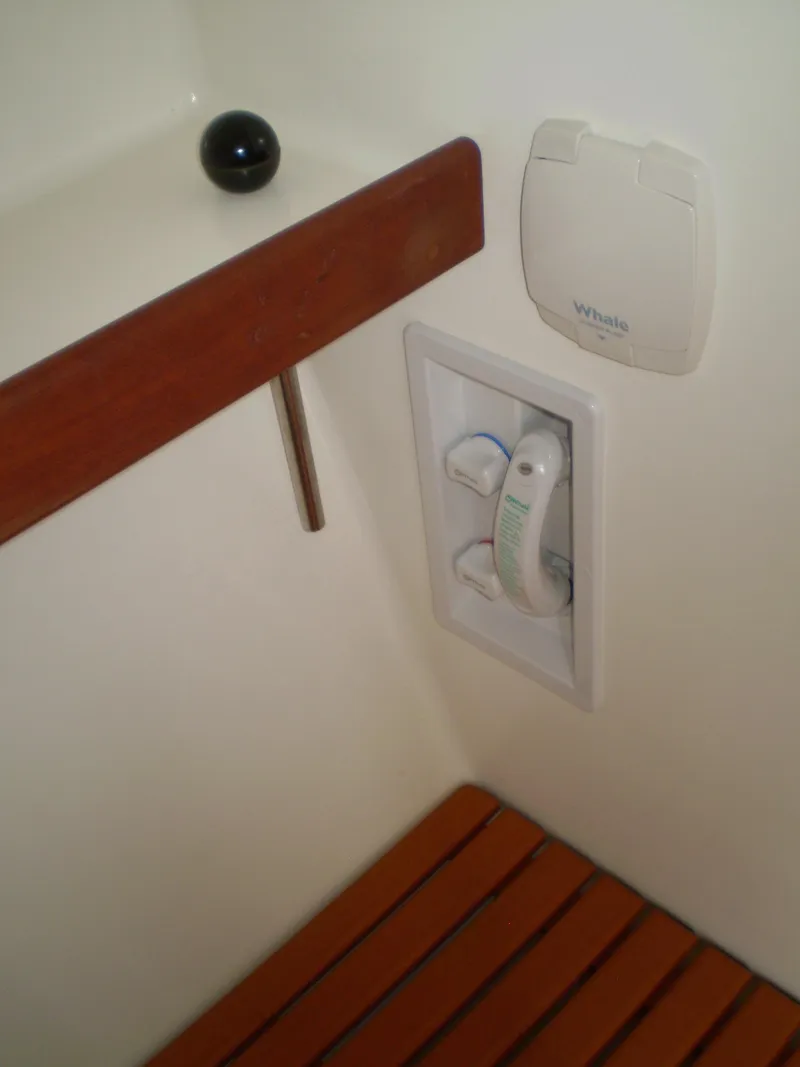 Slide: The Image of Interior of 2000 Devlin Surf Scoter boat with wooden bench and mounted showerhead. - 37