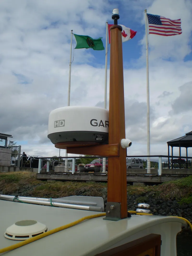 Slide: The Image of Radar equipment on a 2000 Devlin Surf Scoter boat with flags in the background. - 4