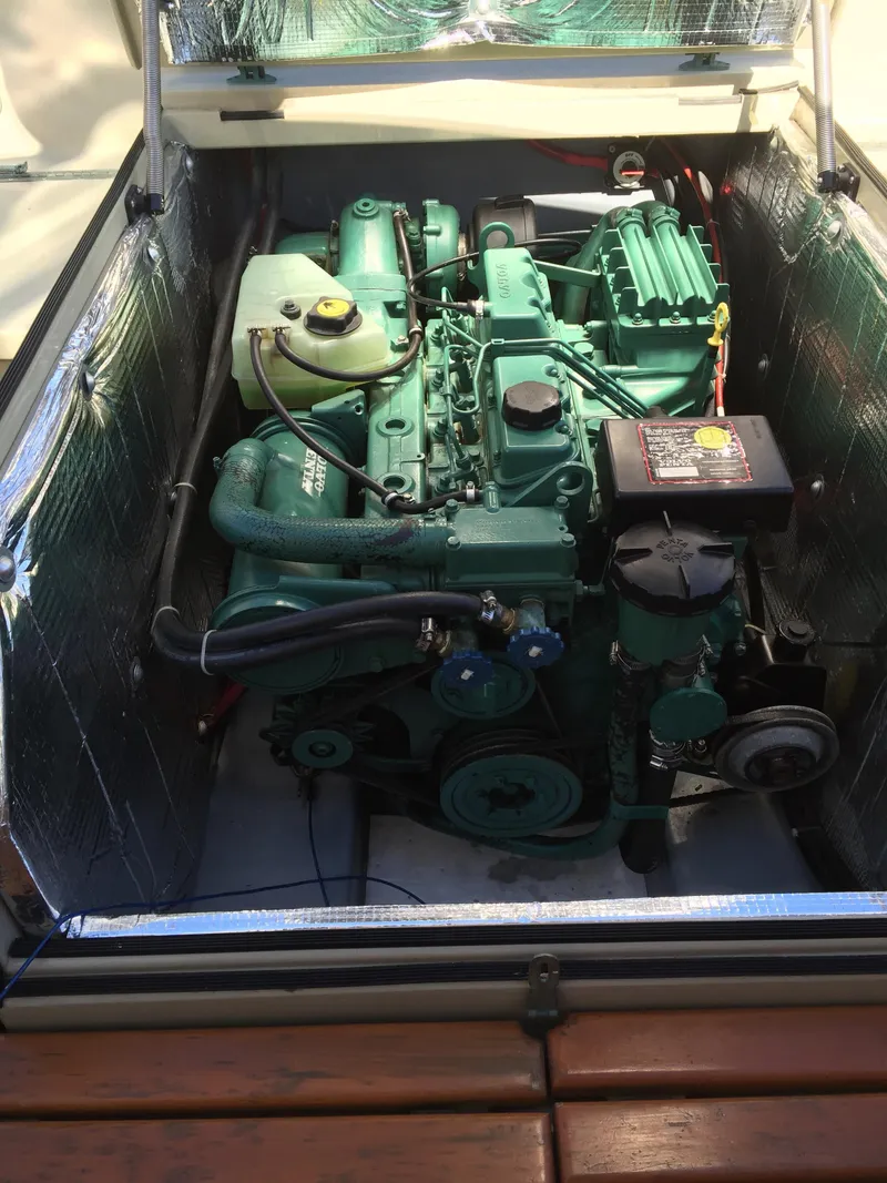 Slide: The Image of Engine compartment of a 2000 Devlin Surf Scoter boat, showcasing a well-maintained marine engine. - 43