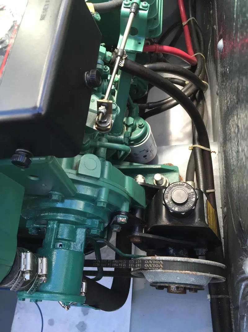 Slide: The Image of Engine compartment of a 2000 Devlin Surf Scoter boat, showcasing mechanical components and wiring. - 44