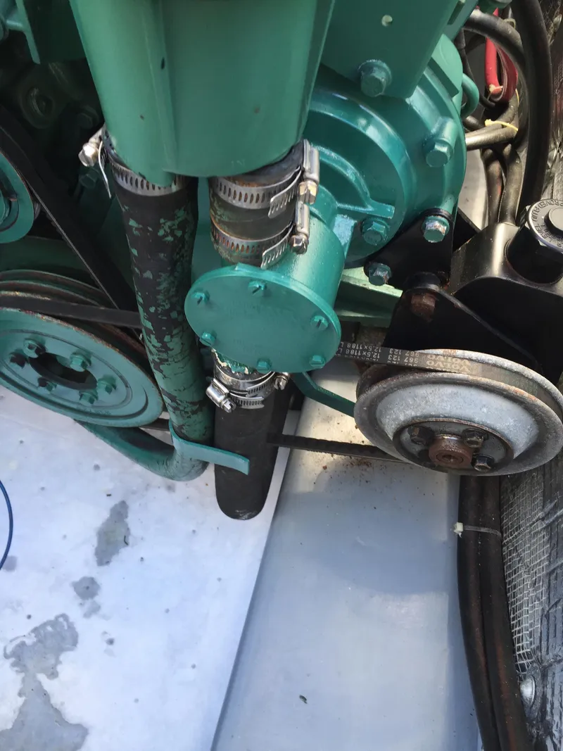 Slide: The Image of Engine components of a 2000 Devlin Surf Scoter boat, featuring belts and hoses. - 46