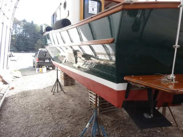 Slide: The Image of Devlin Surf Scoter 2000 boat on stands in a workshop setting. - 49