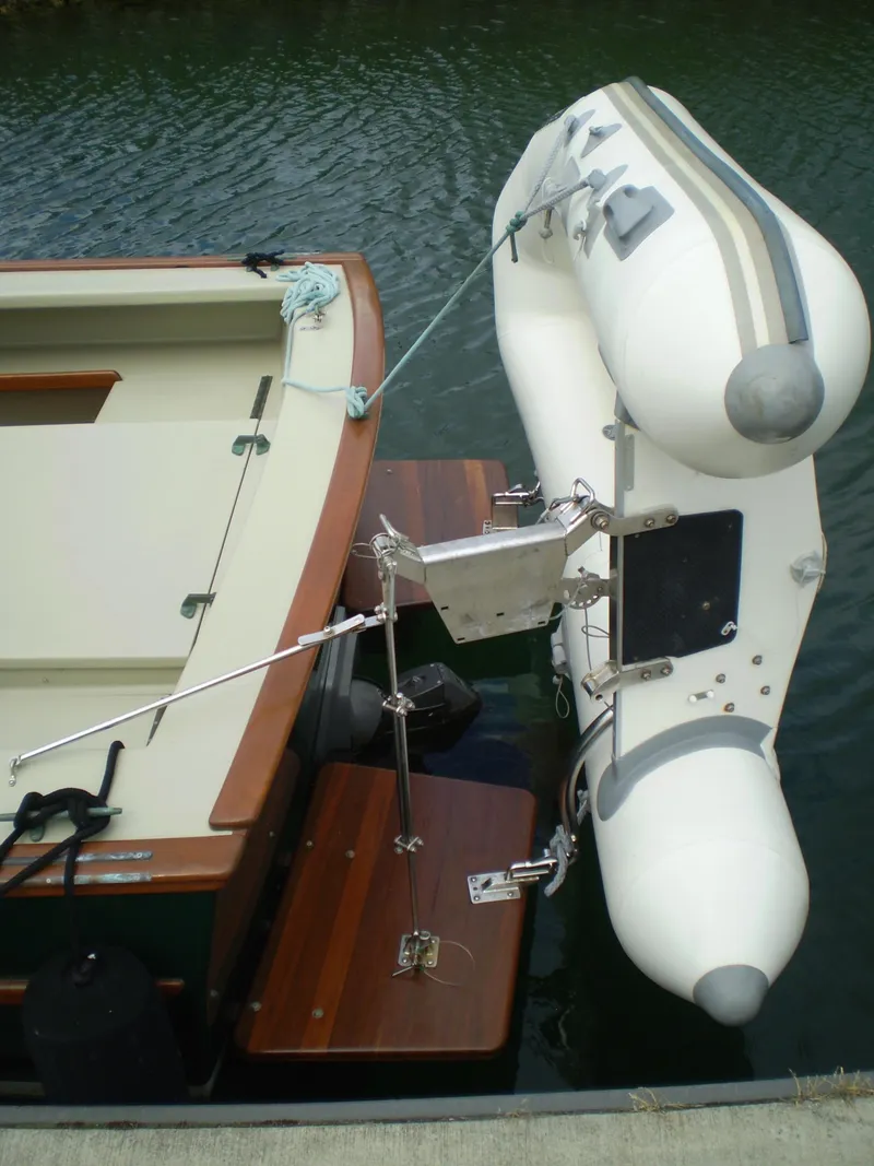 Slide: The Image of Devlin Surf Scoter 2000 with attached inflatable dinghy on calm water. - 7