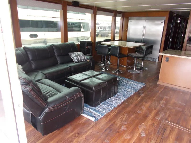 Slide: The Image of Luxurious interior of 2013 Bravada Tranquility Trip 17 houseboat with leather seating and modern dining area. - 1