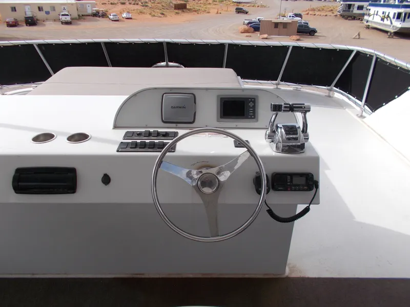 Slide: The Image of Steering console of 2013 Bravada Tranquility Trip 17 houseboat with navigation controls. - 12