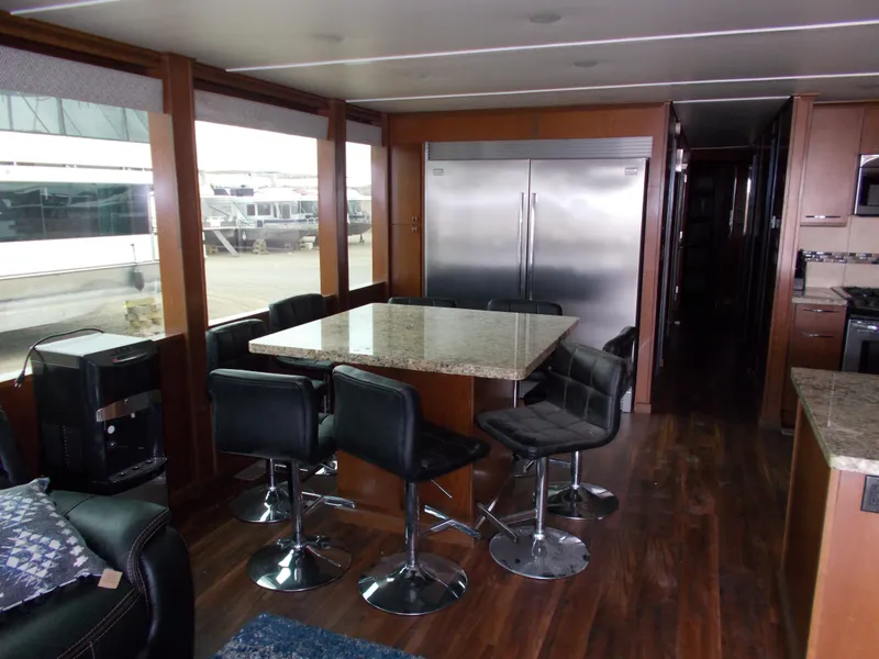 Slide: The Image of Luxurious 2013 Bravada Tranquility Trip 17 houseboat interior with modern kitchen and dining area. - 2